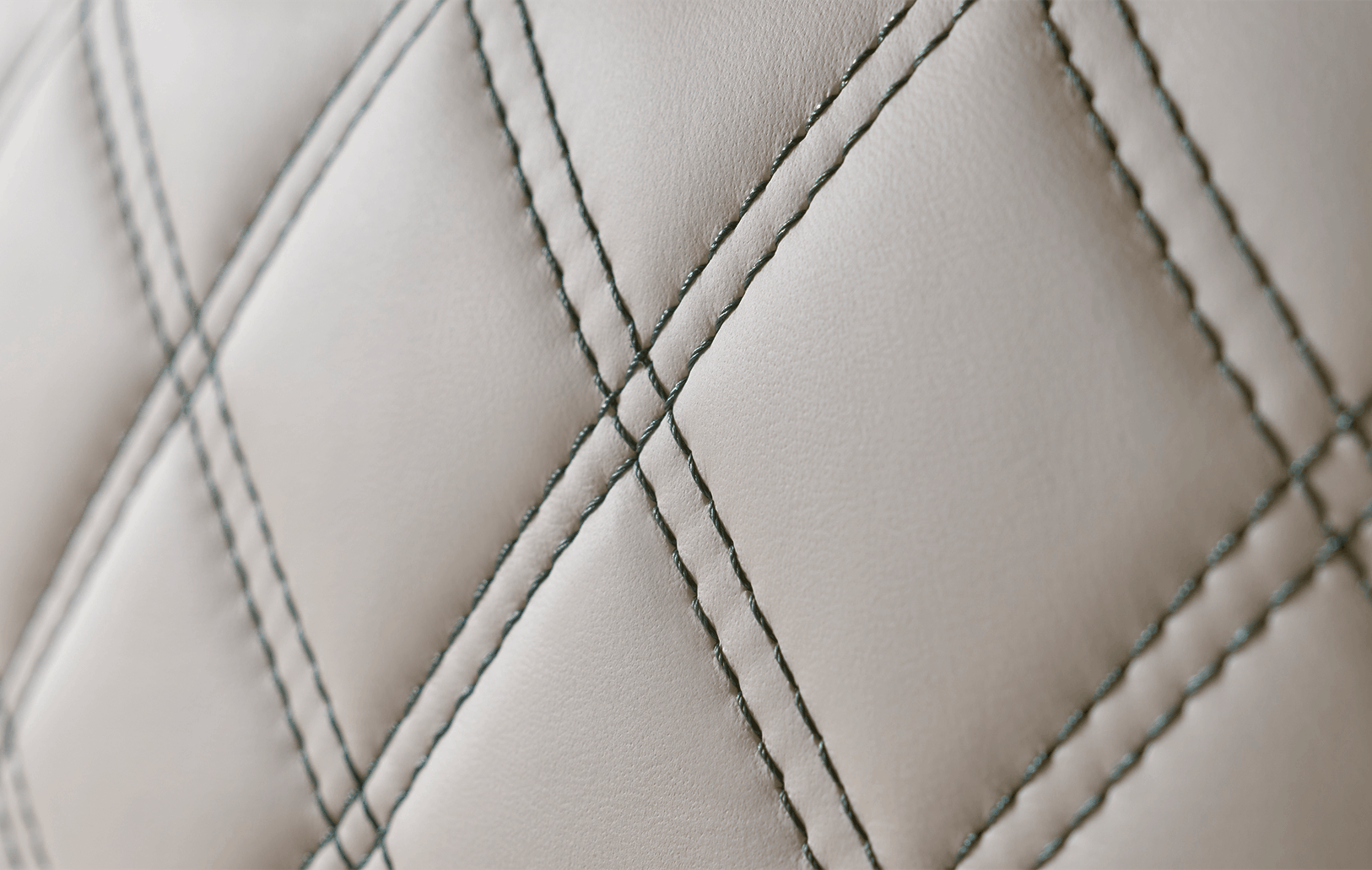 Defender interior with cream-coloured seats and large windows.
