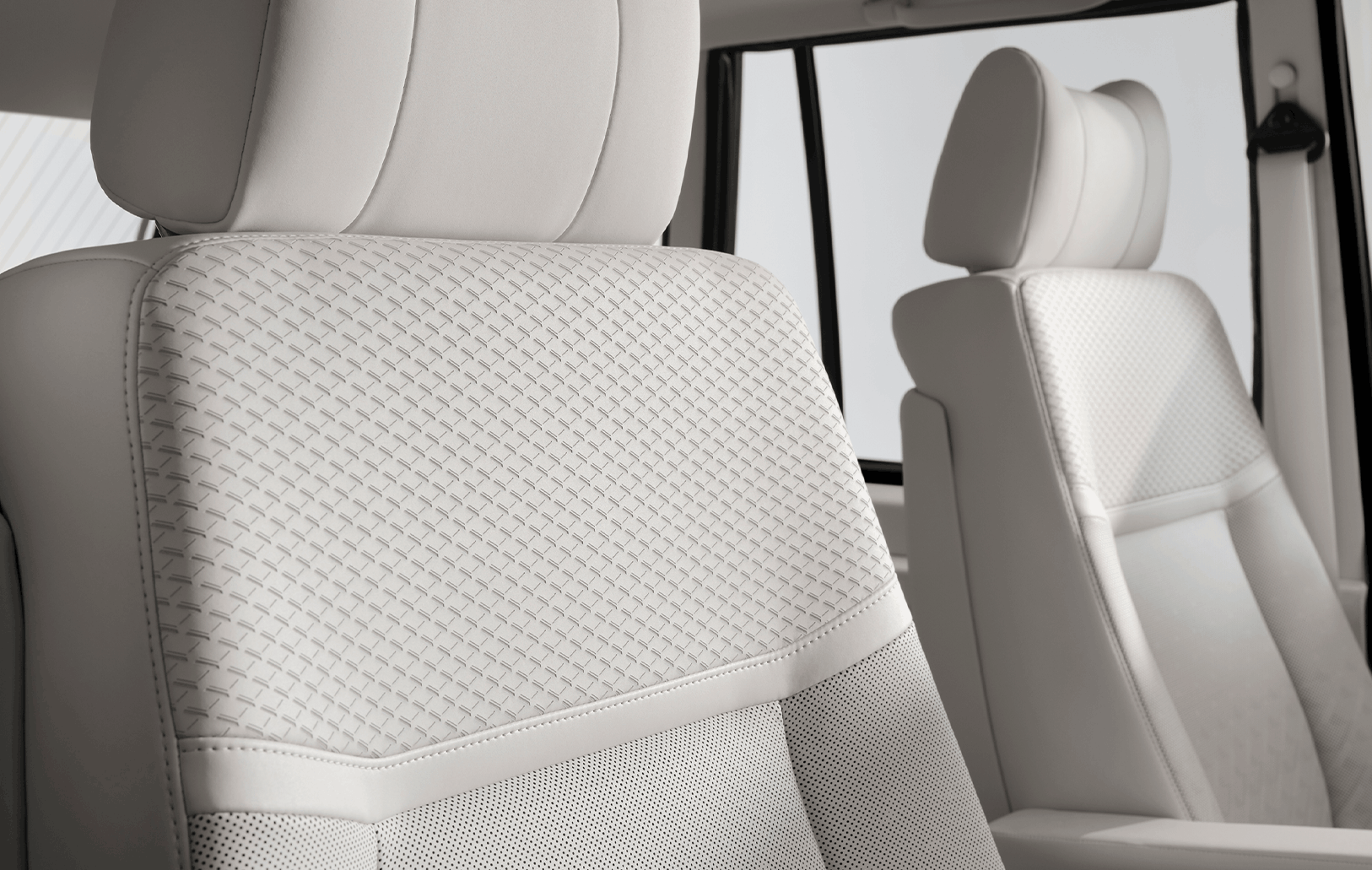 Defender interior with cream-coloured seats and large windows.